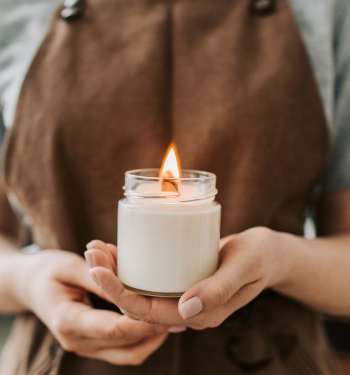 a woman holding a candle to symbolize peace